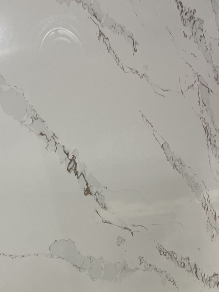 White quartz slab with soft grey and gold veining